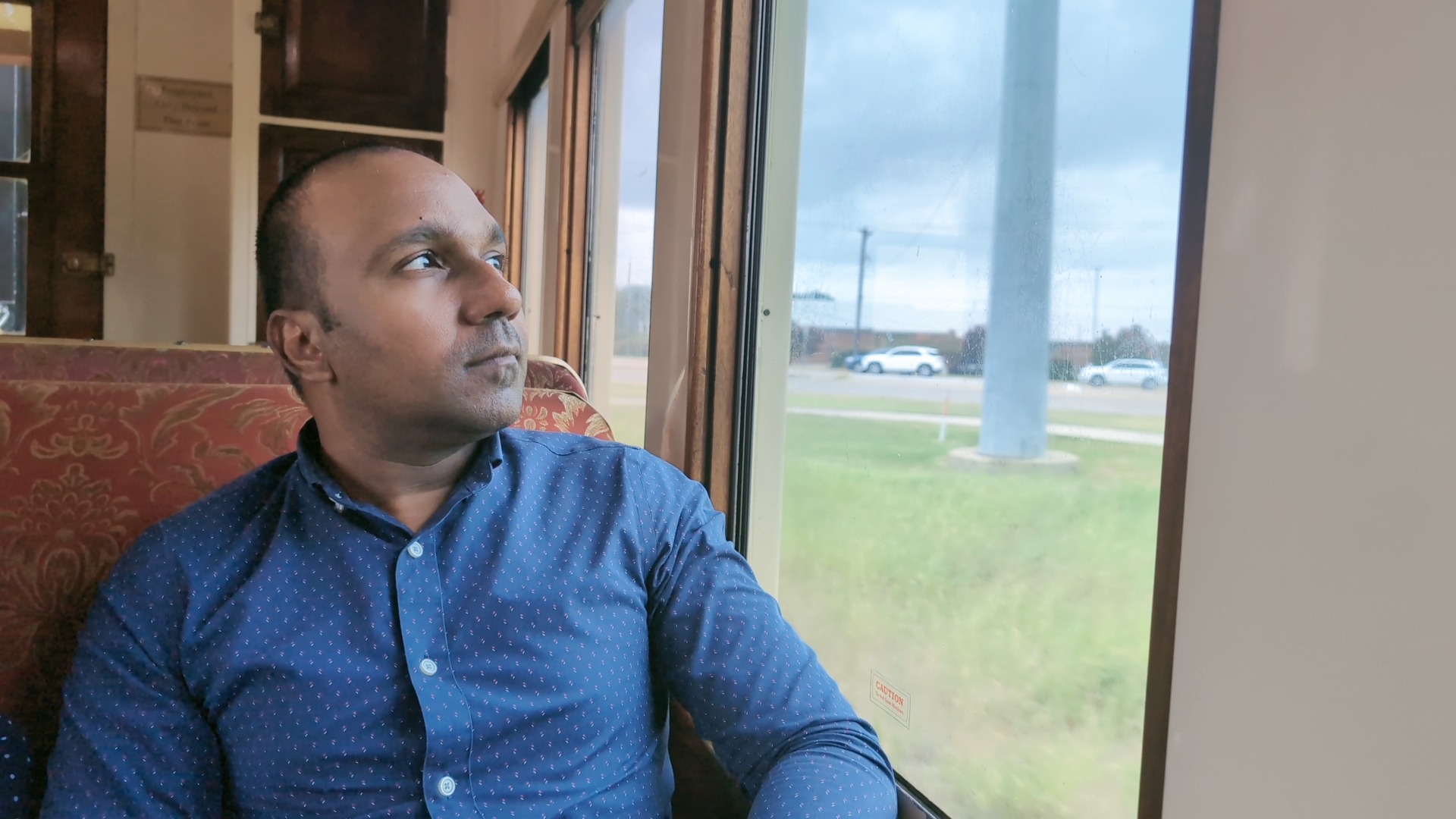 Shyam Uthaman, data and AI leader and author, looking out a train window